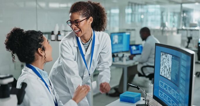 Scientist, high five and computer screen in research lab, women and biotechnology study for immunology. Data, microbial analysis and success in project, drug development and medical breakthrough