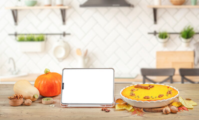 Kitchen tablet pc mockup Autumn baking with pumpkins, nuts. Cooking pumpkin pie for Thanksgiving and autumn holidays