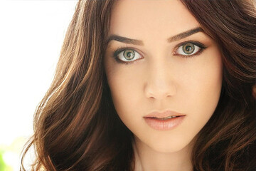 Fototapeta premium Image with beautiful brunette girl touching her face on grey background.