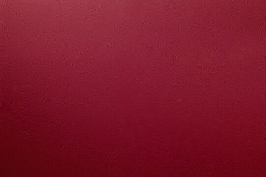 Rich burgundy leather texture background with a luxurious, smooth surface. The deep red tone adds elegance and sophistication to various design projects.