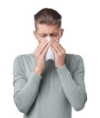 Young man with tissue suffering from sinusitis on white background