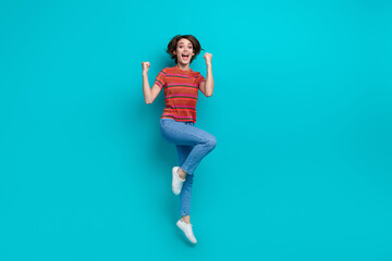 Photo of overjoyed cheerful girl dressed trendy clothes celebrate achievement sale discount scream yeah isolated on cyan color background