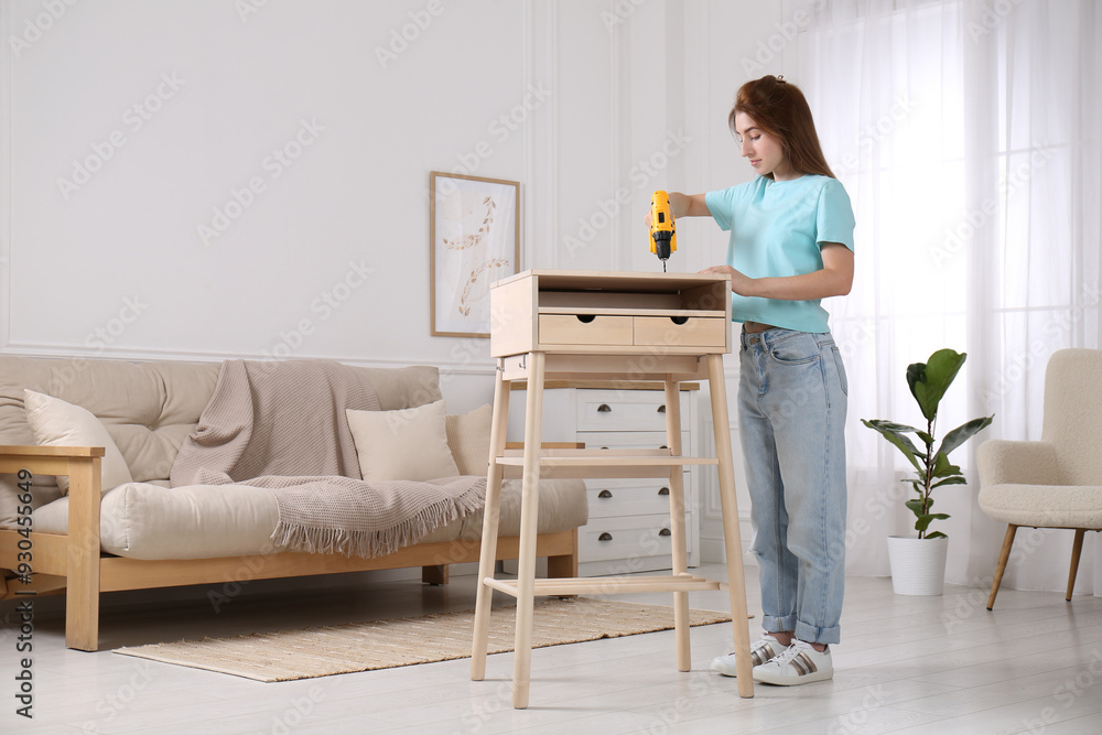 Sticker Woman with electric screwdriver assembling table in room