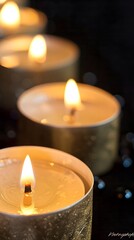 a row of candles in a dark setting