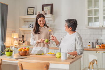 mother day family relation bonding at home asian family mother father and daughter enjoy cuddle conversation morning lifestyle hapiness joyful moment while stay at kitchen area home love bonding