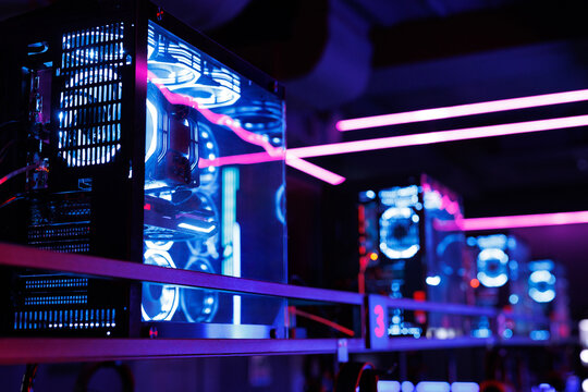Professional gaming computer with neon backlight with headset in the computer club for gamers.