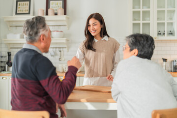 mother day family relation bonding at home asian family mother father and daughter enjoy cuddle conversation morning lifestyle hapiness joyful moment while stay at kitchen area home love bonding