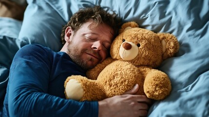 A man sleeping in bed while hugging a teddy bear, showing comfort and relaxation in a cozy setting.