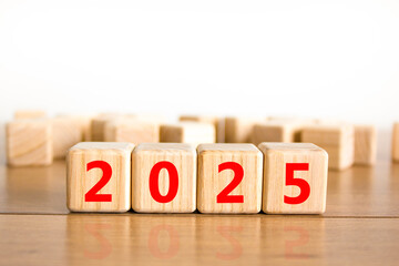 Business concept of 2025 new year symbol. Beautiful wooden cubes with number 2025 Happy new year. Beautiful wooden table white background, copy space. Business 2025 happy new year concept.