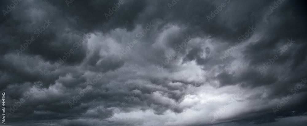 Poster the dark sky with heavy clouds converging and a violent storm before the rain.bad or moody weather s
