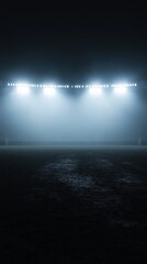 Empty football field illuminated by stadium lights at night