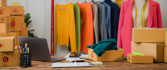 Fashion E-commerce Hub: A bustling workspace overflowing with colorful clothing, prepped packages, and a laptop, embodying the entrepreneurial spirit of online retail. 
