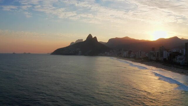 Aerial view of Ipanema and Leblon at sunset, Rio de Janeiro, Brazil, with mountains and coastline.