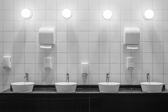 White colour ceramic tiles toilet hand wash area. White colour theme toilet interior. Cleanliness concept. Clean toilet concept.