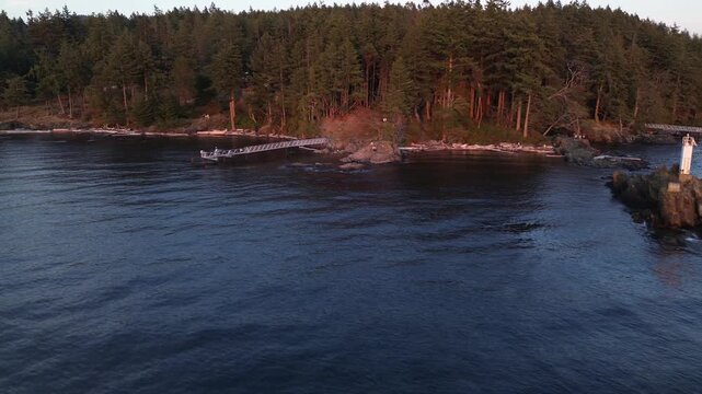 forest behind Cape Roger Curtis Lighthouse with seafront at Bowen Island in British Columbia
