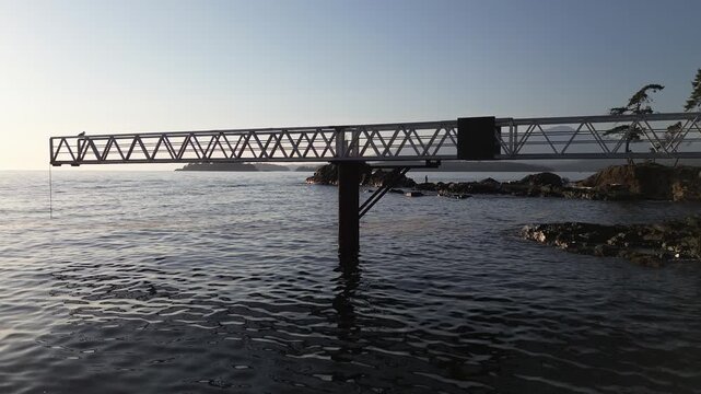 The pier of Cape Roger Curtis Lighthouse on a rocky coastline in Bowen Island, British Columbia