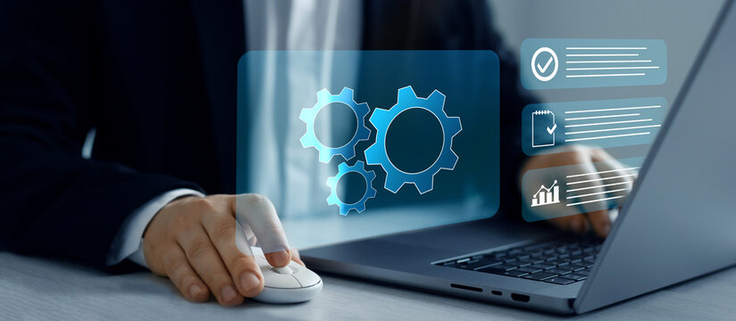 Business process optimisation.Robotic process automation or RPA.Engineer setting up automated software.Automated industrial technology with digital transformation.