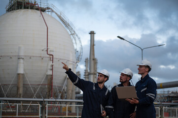 Refinery industry, engineer working on computer laptop at oil and gas refinery plant industry factory