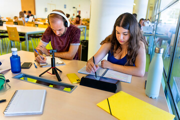 University classmates studying together in the library. Back to school.