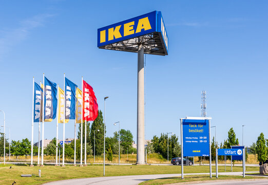Malm&ouml;, Sweden - July 19, 2024: A tall three-sided billboard shows the IKEA sign at the entrance of the IKEA store, alongside IKEA banners.