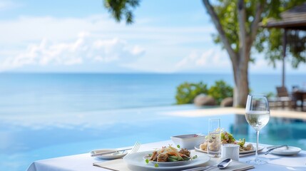 A table with a glass of wine and a plate of food by a pool