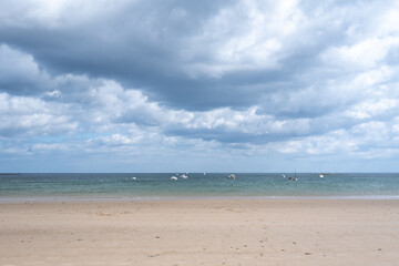 Embleton beach with boats on the sea