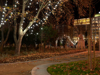 Christmas tree and lights at night in a park.