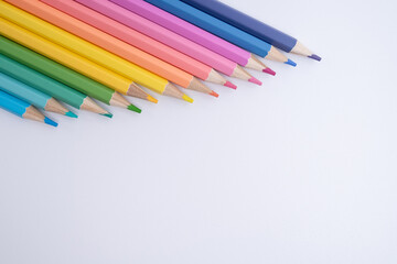 Fototapeta premium Colored pencils on colored background. Back to school concept. Draw