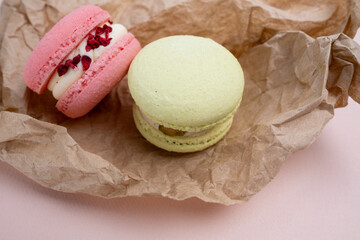 Macarons on a colored background, French cookies. Gift for March 8, International Women's Day, Valentine's Day. Sweets for coffee and tea