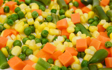 Fresh mixed vegetables on white. Golden mix.