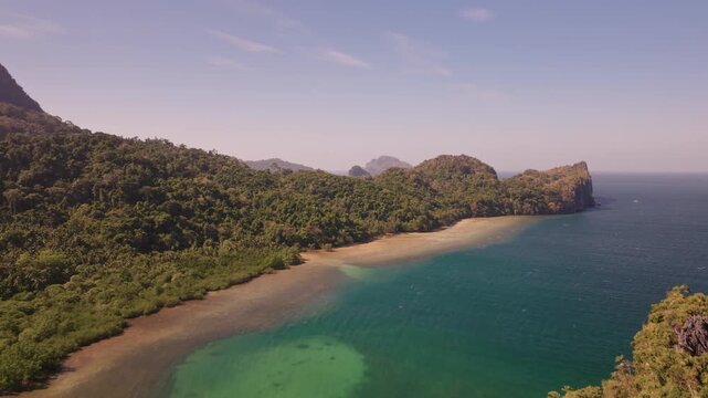 Establishing aerial view of tropical paradise exotic island surrounded by crystal blue sea and sail boats. Travel video of Bukal island El Nido Philippines, untouched nature on sunny summer day