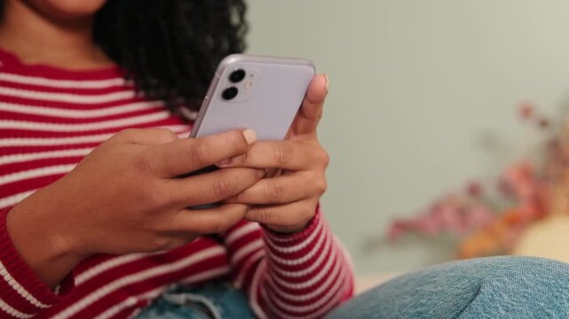 Close-up of woman hands using mobile phone, focus on the phone