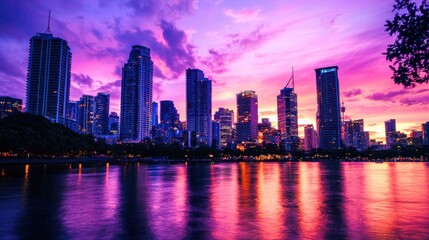 Fototapeta premium Captivating urban landscape at sunset with skyscrapers silhouetted against a vibrant sky. The river reflects the sunset colors
