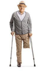 Elderly man without leg standing with crutches and smiling at the camera