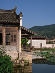 traditional chinese style buildings around pond in a old village