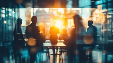 silhouettes of diverse people collaborating and working together in a blurred coworking office space teamwork and cooperation concept toned image