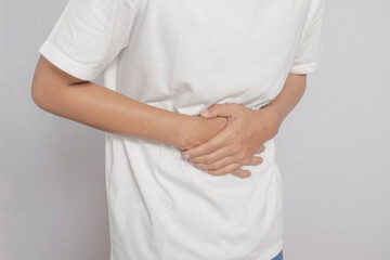 Close up picture of an Asian man, thin, tall, white skin in white Both hands held rice to the...