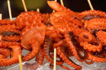 Skewered octopus for sale as street food at a Hong Kong night market.