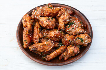Caramelized in sause chicken wings  . Bar-b-q food background photo