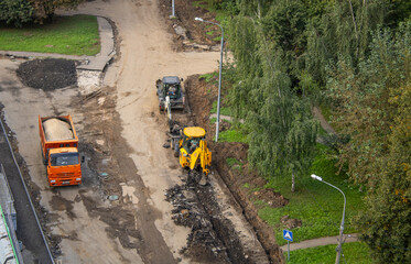 Road works are underway. Powerful equipment is at work: excavators, a truck, a bulldozer