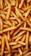 Crispy golden French fries piled high on a wooden platter