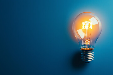 Glowing Light Bulb Against Deep Blue Background in Minimalist Composition