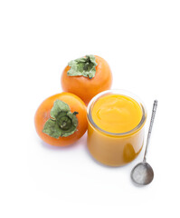 Persimmon puree in glass jar isolated on white