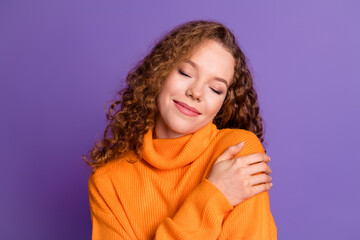 Portrait of lovely young girl closed eyes touch shoulder wear sweater isolated on purple color background