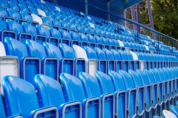 Fototapeta premium Empty seats for fans at a football stadium