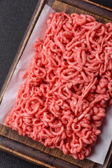 Fresh raw ground beef with salt and spices