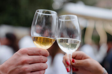  A vertical shot of people holding wine glasses