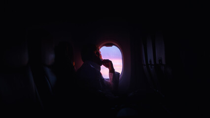 Man looking out from an airplane window © spcXmky