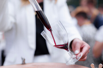 Elegantly serving red wine in a wine boutique