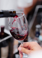 Elegantly serving red wine in a wine boutique